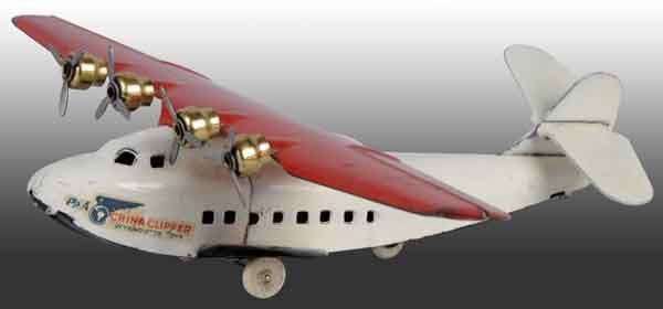 Pressed Steel Wyandotte China Clipper Airplane.: White rubber tires and four original props. Decals on both sides of front with moderate chipping. Moderate overall scratching and wear. Wind-up. 9" L. (Very Good).