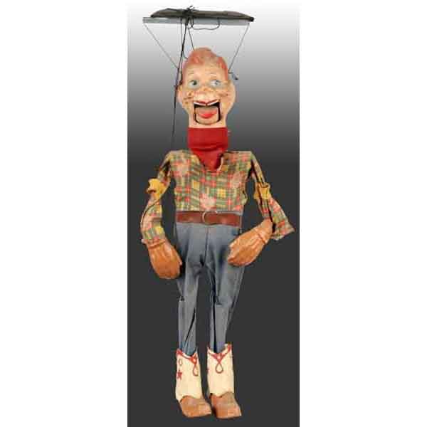 Howdy Doody Marionette.: 1950s. Marked "HD" on both boots. Original clothing. Mouth moves. Some crazing, cracking, and wear to back of head with one piece chipped off of tongue. 16" T. (Good - Very Good).