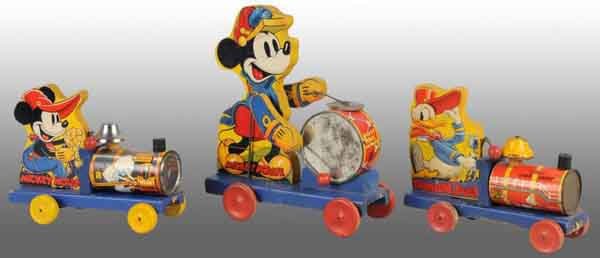 Lot of 3: Fisher Price Walt Disney Pull Toys.: American. Includes two Choo-Choo toys, one Mickey Mouse, one Donald Duck, and one Mickey Mouse drummer. Some paint loss and wear to bell of Donald Choo-Choo, some oxidation to bare metal parts through