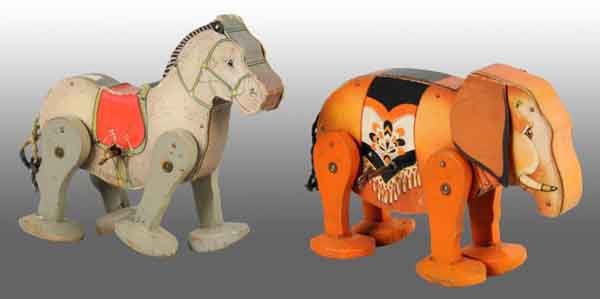 Lot of 2: Fisher Price Go-N-Back Wind-Up Toys.: American. Both are working. Includes one mule with replaced key, missing ears, and pencil writing on both sides. Also includes one Jumbo with original ears and missing trunk. Largest: 8 - 1/2" T. (Ver