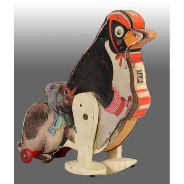 Fisher Price No. 345 Penelope Penguin Toy.: American. 1935. Working. Very scarce. One side of toy has all original paper while the other side has paper that's been redone. Some paper loss to back of penguin. 9" T. (Very Good - Excellent).