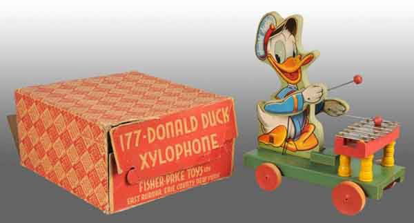 Fisher Price No. 177 Donald Duck Xylophone Toy.: American. 1946. Original arms and mallets. Slight oxidation to bare metal keys. Includes complete original box with some creasing and tearing. 13" T. Toy (Excellent) Box (Very Good).
