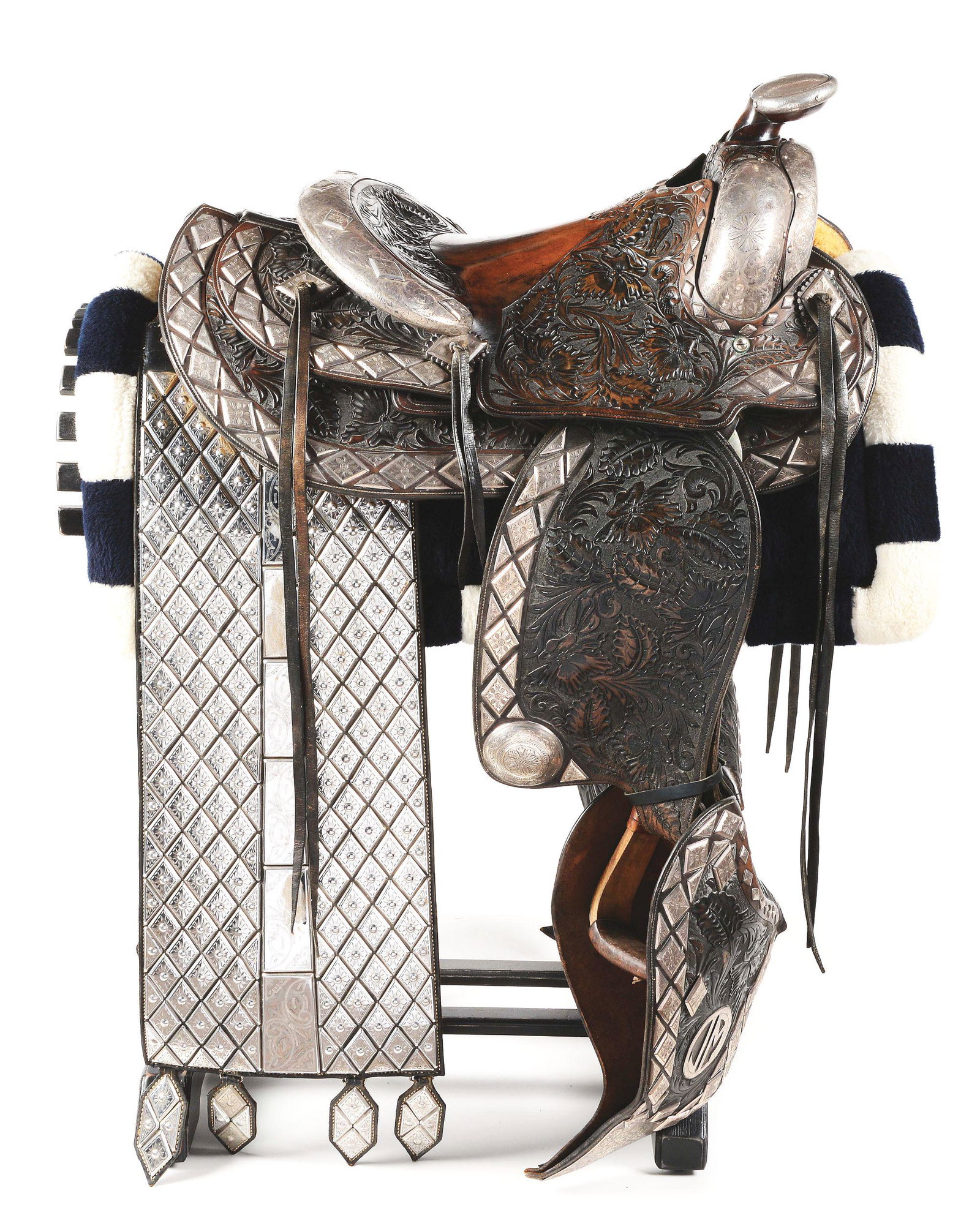 DON ELLIS SILVER PARADE SADDLE.: A spectacular silver mounted parade saddle with extensive leather carving and engraved silverwork. The saddle is marked "KARL'S SEATTLE" which Don Ellis worked for. Saddle is mounted with sterling sil