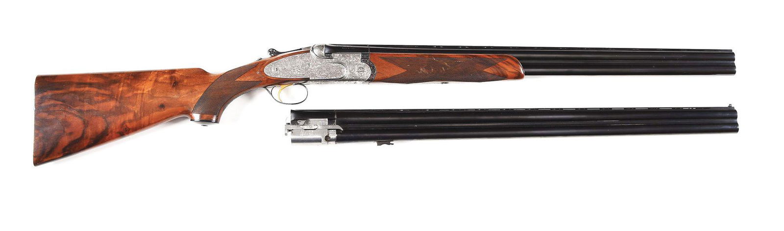 (M) BERETTA SO5EELL 12 BORE 2 BARREL SET SHOTGUN WITH: Circa 1971. An Over Under game gun with 2 sets of monobloc blued steel barrels and ejectors. Barrel lengths are (A) 26" and (B) 28". Barrels are built with low profiled matte ventilated ribs with 2 -