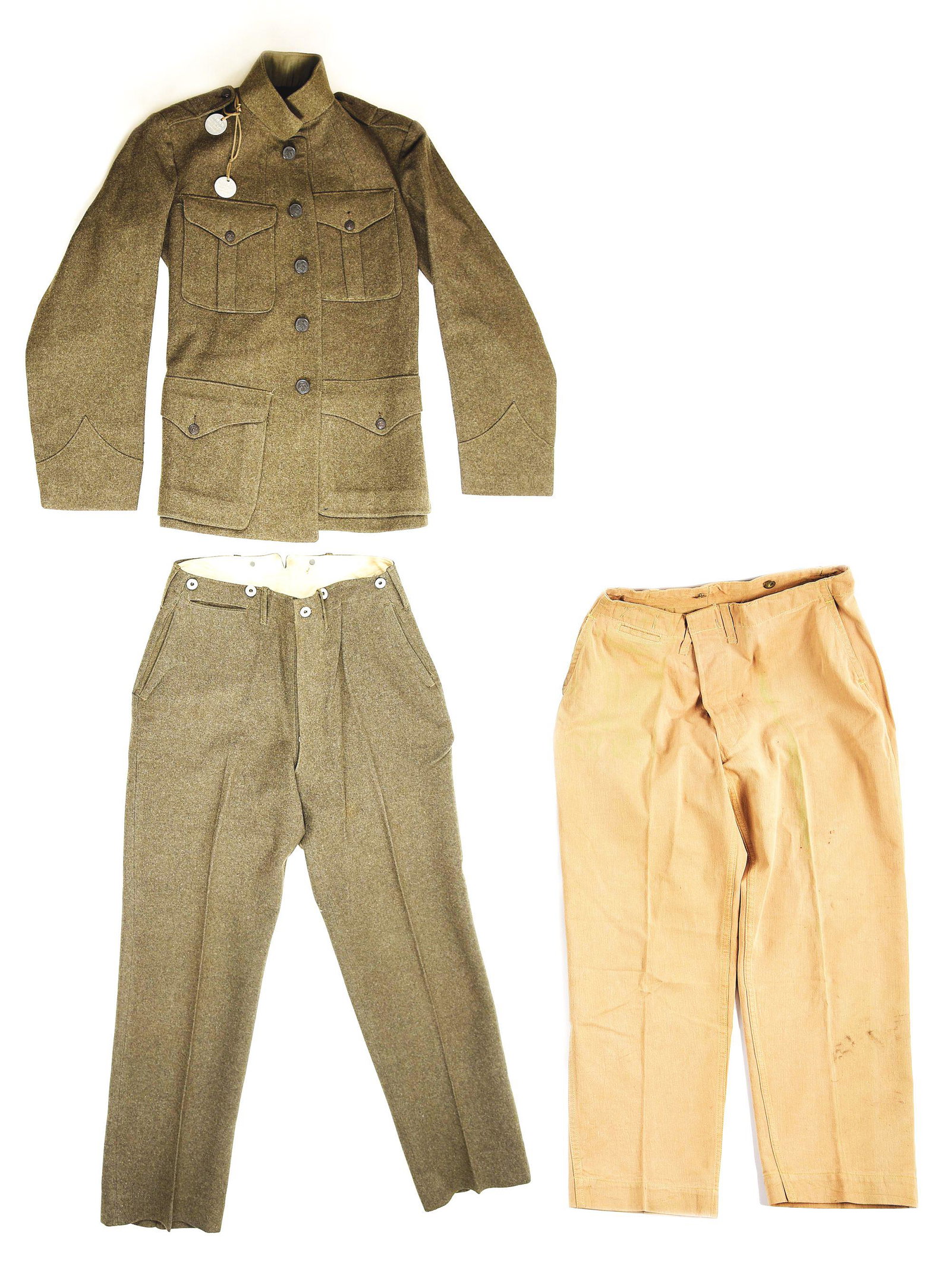 ID'D WORLD WAR I USMC BROTHERS UNIFORM AND DOG TAG: World War I US Marine Corps brothers grouping consisting a of Patten 1917 tunic and trousers, and a pair of Pattern 1912 khaki trousers named to Wendell L. Onstine with dog tags from his brother Evere
