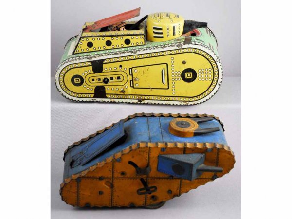 Lot of 2: Marx Tin Wind-Up Doughboy Tank Toys.: Circa 1920s. Two variations. Both working. Moderate scratching and wear and some pitting throughout. Largest: 10" L.