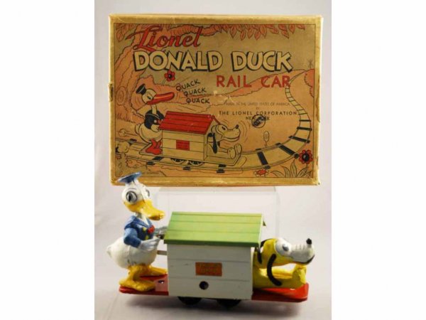 Lionel Walt Disney Donald Duck & Pluto Rail Car.: Working. Composition figures with pressed steel base and dog house. Includes original box marked #1107 with insert and track. Nice color lithography. Original price tag of $1.00 stamped in front. Toy 