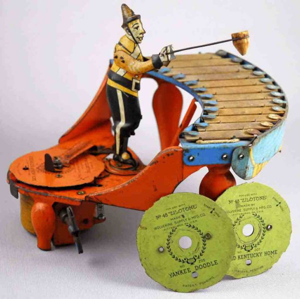 Wolverine Wind-Up Zylotone Toy.: Working. Includes three original records: Sidewalks of NY, My Old Kentucky Home, and Yankee Doodle. Moderate overall fading and wear throughout. Rusting to piano keys. 7 - 1/2" T.