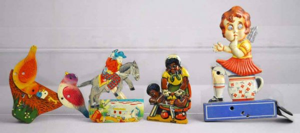 Lot of 4: Tin Litho Clicker Toys.: German and Japanese. Includes Japanese birds and a Japanese cowboy on a horse rider. Also includes a German girl sitting on a potty, when squeezed a rat jumps out of the potty and the other is an Afri