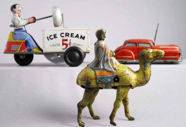 Lot of 3: Tin Litho Wind-Up Toys.: Includes Kohrland Ice Cream Scooter, German Arab Riding Camel, and French Magic Car. All three wind-ups are slipping. Pitting and rust to camel toy. Largest: 6 - 1/2" L.