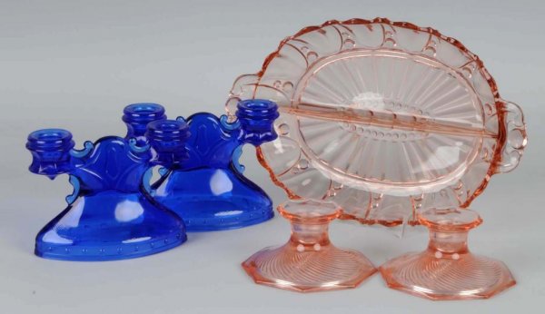 Lot of 5: Depression Glass Pieces.: Includes one pair of cobalt blue candle holders, one pair of pink candle holders, and one pink divided serving dish. No cracks or damage. Largest: 11 - 1/2" L.