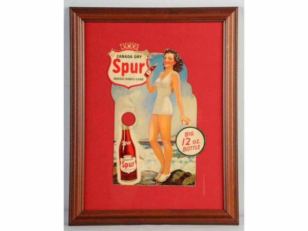 Cardboard Spur Bathing Girl Bottle Display.: 1940s. Framed under glass. Bottom easel is missing. General overall marks and wear with one nail hole to top center. Displays well. 13 - 1/2" x 8 - 1/2".