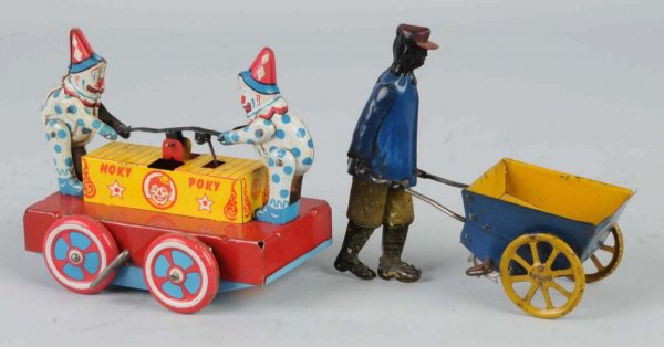 Lot of 2: Tin Wind-Up Toys.: American. Working. Includes Strauss Tip-Top Porter and Wyandotte Hoky-Poky Clown car. Moderate scratching and wear to both. Largest: 6" L.