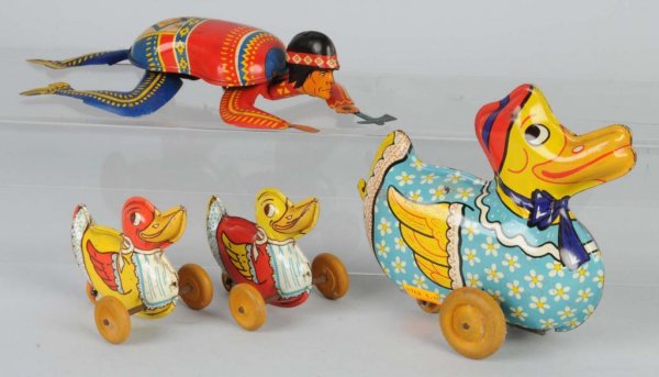 Lot of 2: Tin Litho Toys.: American. Includes Ohio Art Injun Joe and Wyandotte Duck Parade missing wire connectors. Largest: 8" L.