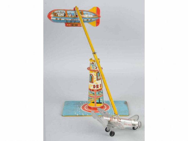 Tin Unique Art Sky Rangers Wind-Up Toy.: American. Working. Includes one airplane and one zeppelin flying around tower. Nice, colorful lithography. 8 - 1/2" T.