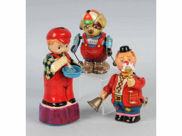Lot of 3: Tin Figural Wind-Up Toys.: Japanese. Working. Includes one dog skiing, one clown ringing a bell, and one boy blowing bubbles. Nice lithography throughout. Largest: 7 - 1/2" T.