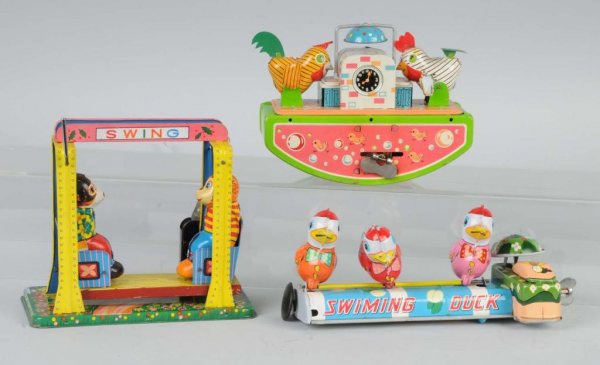 Lot of 3: Tin Animal Wind-Up Toys.: Japanese. Working. Includes one monkey swing missing flag, one pecking roosters, and one swimming ducks. Nice lithography throughout. Largest: 6" x 6 - 1/4".