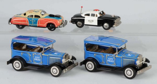 Lot of 4: Tin Police Car Friction Toys.: Japanese. Working. Nice lithography throughout. Largest: 6 - 1/4" L.
