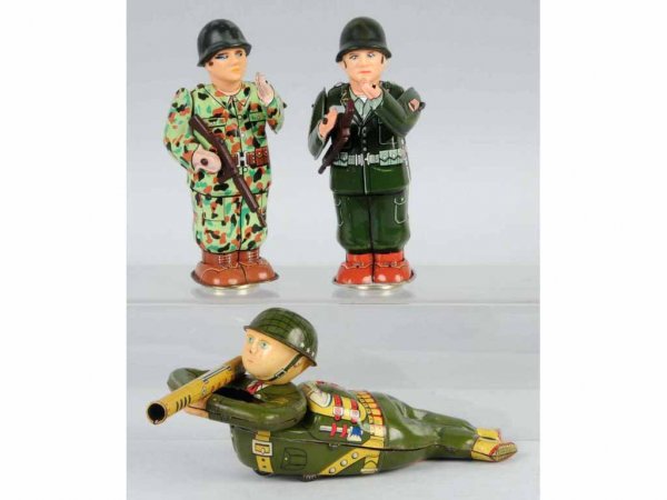 Lot of 3: Tin Soldier Wind-Up & Friction Toys.: Japanese. Working. One solider is holding a bazooka, which is unusual for this toy. Largest: 9 - 1/2" L.