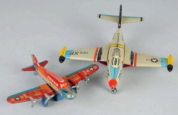 Lot of 2: Tin Airplane Friction Toys.: Japanese. Working. Includes one Navy Bomber with folding wings. Beautiful lithography. Largest: 8 - 1/2" x 8".