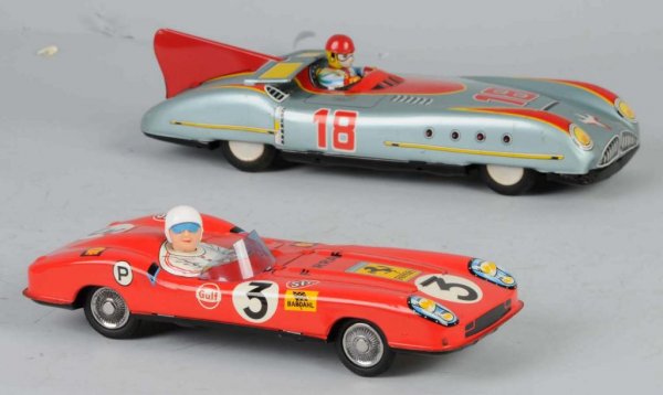 Lot of 2: Tin Race Car Friction Toys.: Japanese. Working. One marked "3" and the other "18". Larger car has folding rear wind screen. Some scratching and wear throughout. Largest: 11" L.