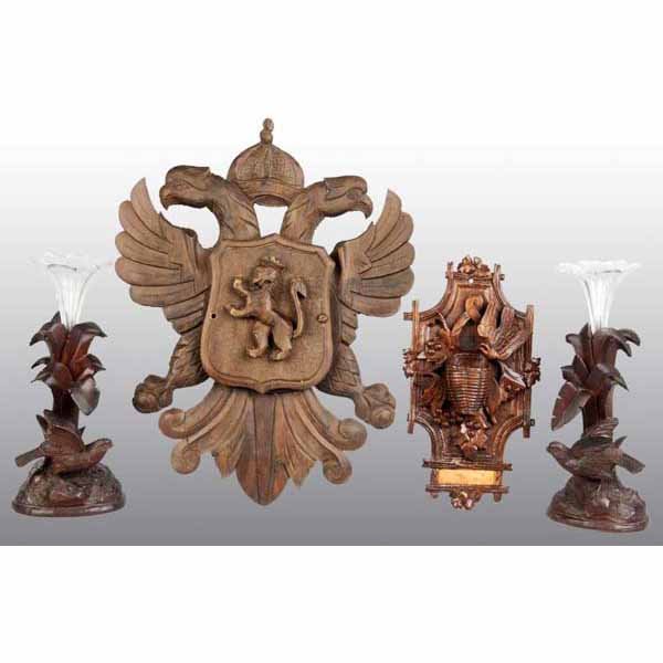 Lot of 4: Carved Black Forest Objects.: Late 19th century. Includes wall mounted match holder, a pair of vase holders with original glass flower holders, and a two-part wall plaque. All are carved walnut. Largest: 15" L.