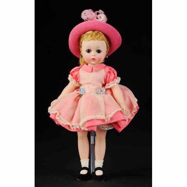 Lovely and Rare Hard Plastic Alexander Kelly.: American. Ca. 1959. Lissy-faced doll with rosy cheeks, lashed blue sleeping eyes, earrings, perfect blonde wig with original fancy set. Tagged Kelly pink taffeta dress with pinafore, matching straw ha