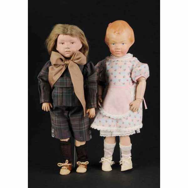 2 All Wood Schoenhut Dolls.: American. Ca. 1911. Girl with molded and carved hair with pink bow, completely refinished head with blue intaglio eyes and smiling mouth with teeth. Fully metal jointed body has Schoenhut impressed ma