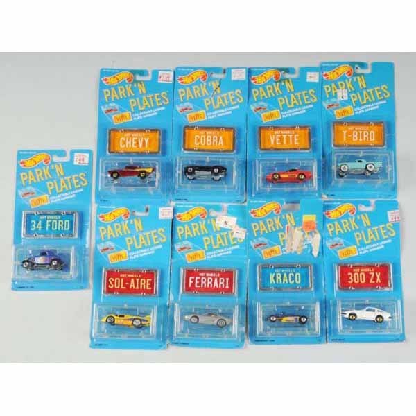 Lot of 22: Mattel Hot Wheels Park 'N Plates.: Includes Thunderbird, 1957 Chevy, Corvette, and others. Mint in plastic boxes with license plates, some creasing and waviness throughout. Not all pictured.