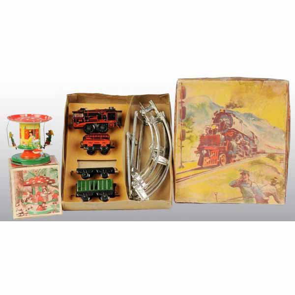 Lot of 2: Tin Go-Around & Train Set Toys.: German. Both wind-up mechanisms are working. The Go-Around toy is lever-activated and has gnomes that move around a mushroom cap. Includes both original boxes, a beautiful color image of train on its