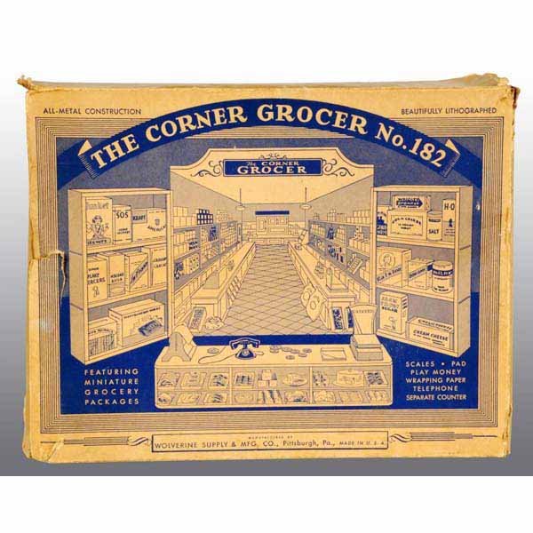 Tin Litho Wolverine No. 182 Corner Grocery Toy.: American. Beautiful lithography and quite elaborate display includes tin scale, tin roller, and old cardboard grocery store product boxes. Appears to be mostly complete. Includes original box and inse