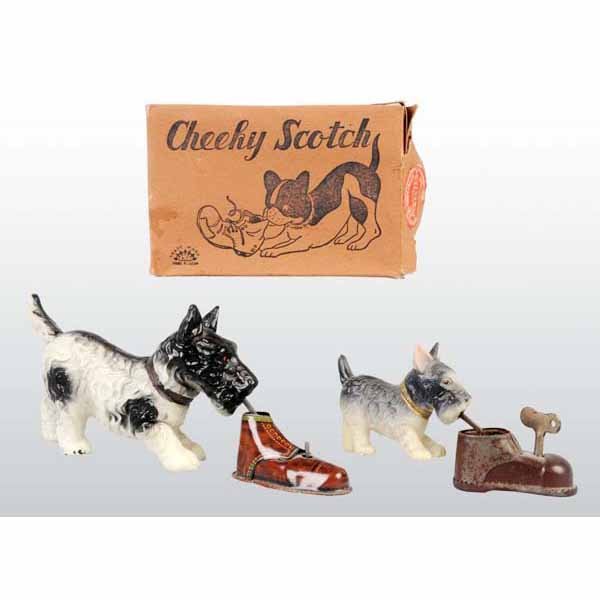 Lot of 2: Celluloid Dog Wind-Up Toys.: Japanese. Pre-war. Both are working. One toy depicts dog playing with shoes with some pitting and oxidation. Includes one original box with some creasing and wear. Largest: 5 - 3/4" x 1 - 3/4" x 4".