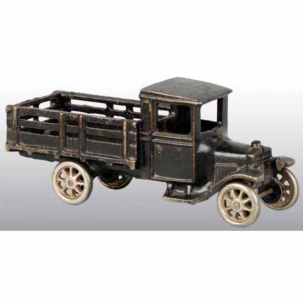 Cast Iron Arcade Model T Stake Truck Toy.: American. Circa 1927. Nickel wheels and original back gate. Marked "Arcade Manufacturing Company" on bottom. Moderate paint loss and wear. 7" L.