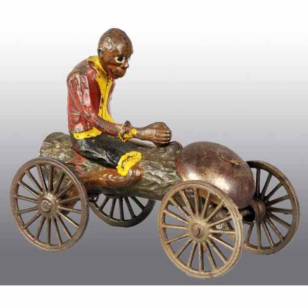 Cast Iron Monkey with Coconut Bell Toy.: Original bell and spoked wheels. Some overall paint loss and wear throughout. 6" x 5".