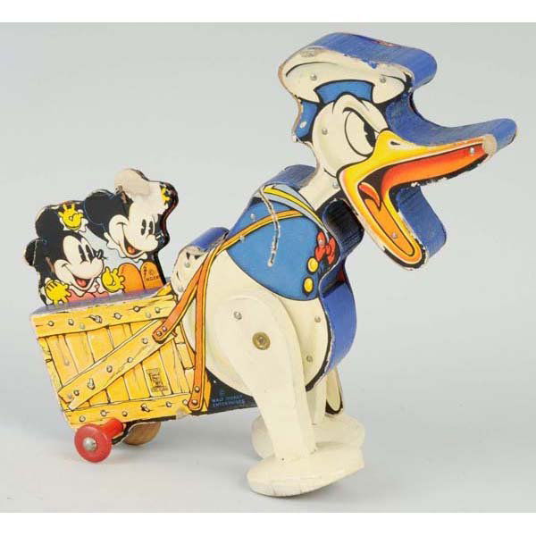 Fisher Price Walt Disney Angry Donald Duck Toy.: Description Paper on wood. Number 358. Wind-up mechanism is working. One original arm but is missing the other. Some paper loss to Minnie's right ear. Condition (Very Good). Size 10" L.