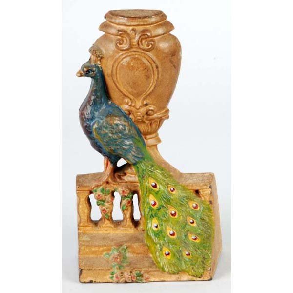 Cast Iron Peacock by Urn on Fence Doorstop.: Description Made by Hubley. Condition (Excellent). Size 8" T.