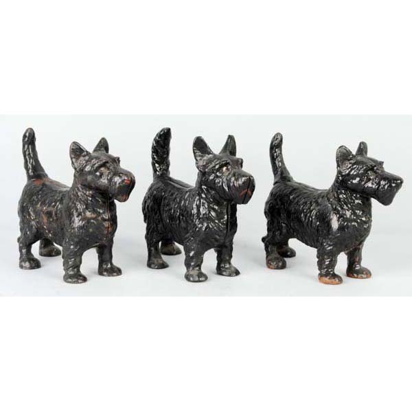 Lot of 3: Cast Iron Standing Scottie Doorstops.: Description National Foundry and Hubley. Assorted Scotties with tail variations. Condition (Very Good). Size Largest: 9" T.
