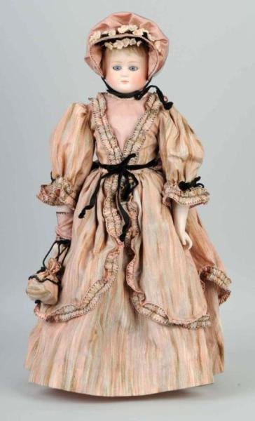 German Bisque Closed Mouth Lady Doll.: Bisque shoulder head incised 1044 by Alt, Beck & Gottschalck, stationary glass eyes, remains of mohair wig, rivet-jointed kid body with bisque lower arms. Size: 20" T.