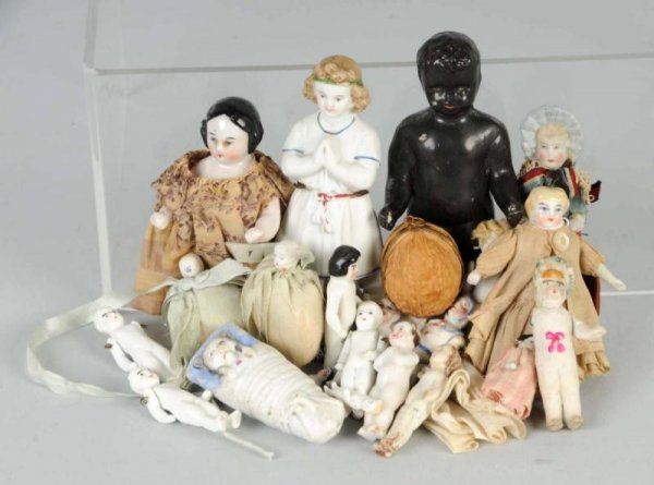 Lot of 21: China & Bisque Dolls.: Early china frozen charlotte with covered wagon hairdo, beautiful painting, original dress; black china frozen Charlie; parian bisque girl with molded hair and clothes; doll house sized blonde china w