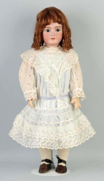 Large Bisque Child Doll.: Incised DEP, produced by Jumeau, sleeping eyes, no upper eyelashes, open mouth, pierced ears, replaced wig, French jointed composition and wood body (repainted torso and hands), nicely dressed. Size: 