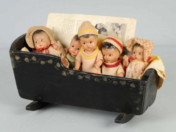 5 Composition Quintuplets in Wood Cradle.: Unmarked composition babies in original clothes with an old black handpainted cradle. All dolls have original clothes, but not matching. Compo needs cleaning, clothes need laundering. Size: Largest: 7
