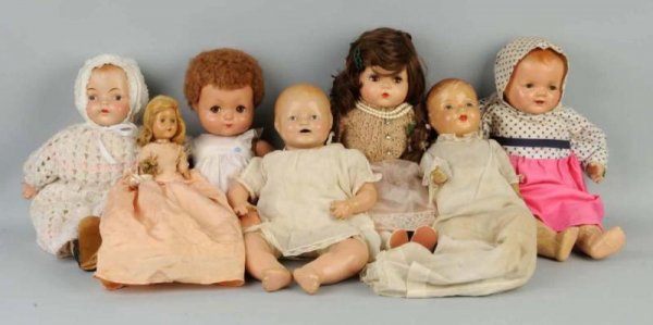 Lot of 7: Composition Dolls.: Effanbee all-compo Sweetie Pie with caracul wig and flirty eyes, original dress; Unmarked mama doll with molded hair and painted eyes; unmarked mama doll (crazed and peeling legs); early baby with clo