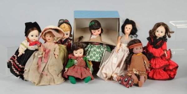 Lot of 7: Dolls.: Madame Alexander Bent-knee Dolls, all original, including rare Indian girl, Spanish, Mexican, Scottish and Swedish (some missing shoes and hats); Alexander Lil' Christmas Cookie 341 in box bottom; com