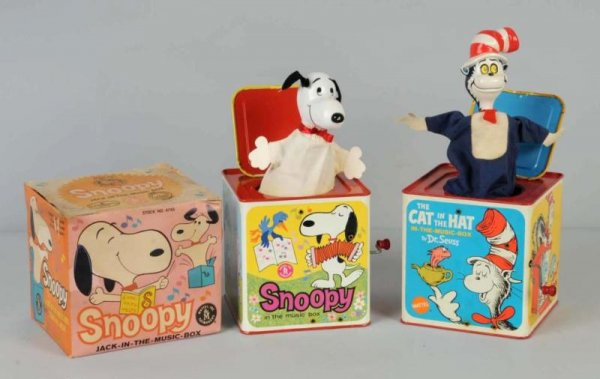 Lot of 2: Character Jack-in-the-Box Toys.: Working. Both made by Mattel. Includes one Snoopy marked "1966 United Features Syndicate" and one Cat in the Hat marked "1970 Dr. Seuss". Both with nicely depicted scenes of characters on all sides. C