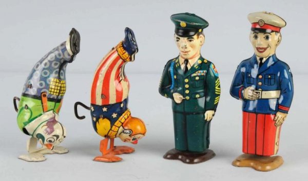 Lot of 4: Tin Chein Figural Wind-Up Toys.: American. Working. Includes one marine, one sailor, and two handstand clowns. Three are marked with the Chein shield emblem. Some scratching throughout all toys. Size: Largest: 5 - 1/2" T.