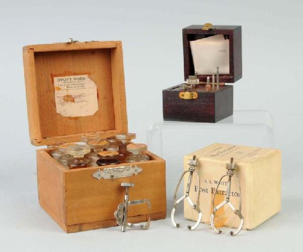 Lot of 5: Dental Tools.: Includes one post extractor, three clamps, and one wooden box with jars. Size: Largest: 3 - 1/4" x 3 - 3/4".