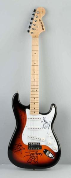 Sunburst Fender Aerosmith Guitar with COA.: Sunburst Fender Electric Guitar autographed by Aerosmith. Signatures include: Tom Hamilton, Brad Whitford, Steven Tyler, Joey Kramer, Joe Perry. Signed in black. Includes COA's from The Legacy Collect