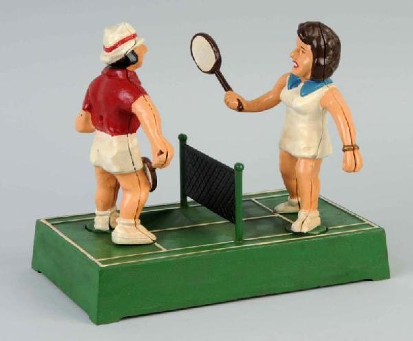 Cast Iron Billie Jean King Tennis Mechanical Bank: Circa 1975. 250 were made by John Wright. Depicts Billie Jean King versus Bobby Riggs. Size: 8 - 3/4" T.