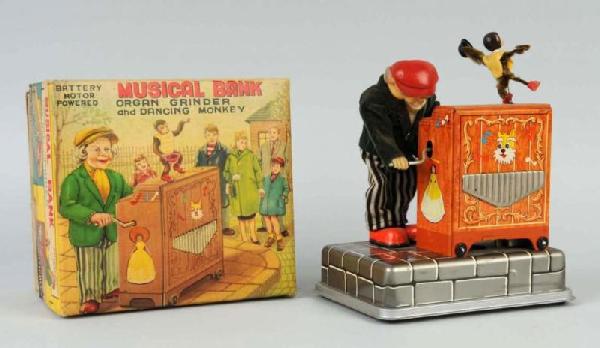 Tin Musical Organ Grinder & Monkey Bank.: Battery-operated. Plays tune and monkey danced. Includes rare original box. Size: 8" T.