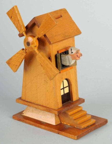 Wooden Folk Art Mechanical Windmill Bank.: Man pop out of side. Size: 9" T.